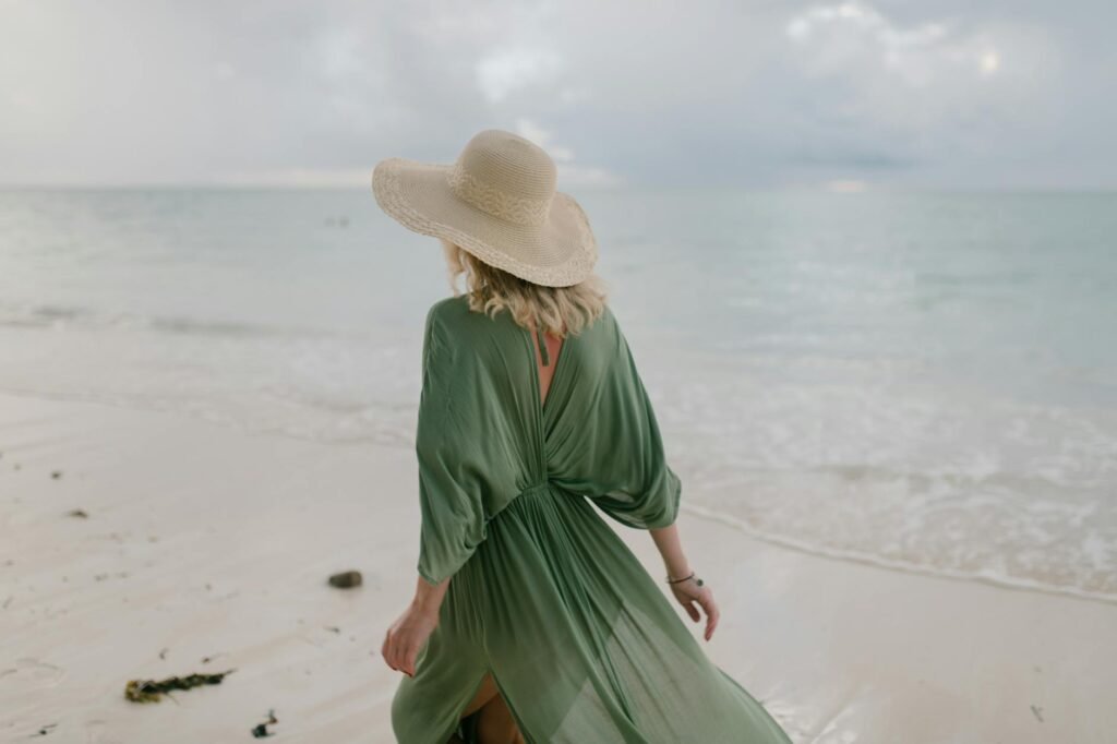 woman with flying dress standing on wet beach